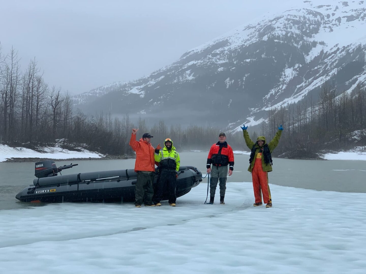 A group of people standing next to an inflatable boat.