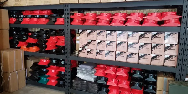 A shelf filled with boxes and red caps.