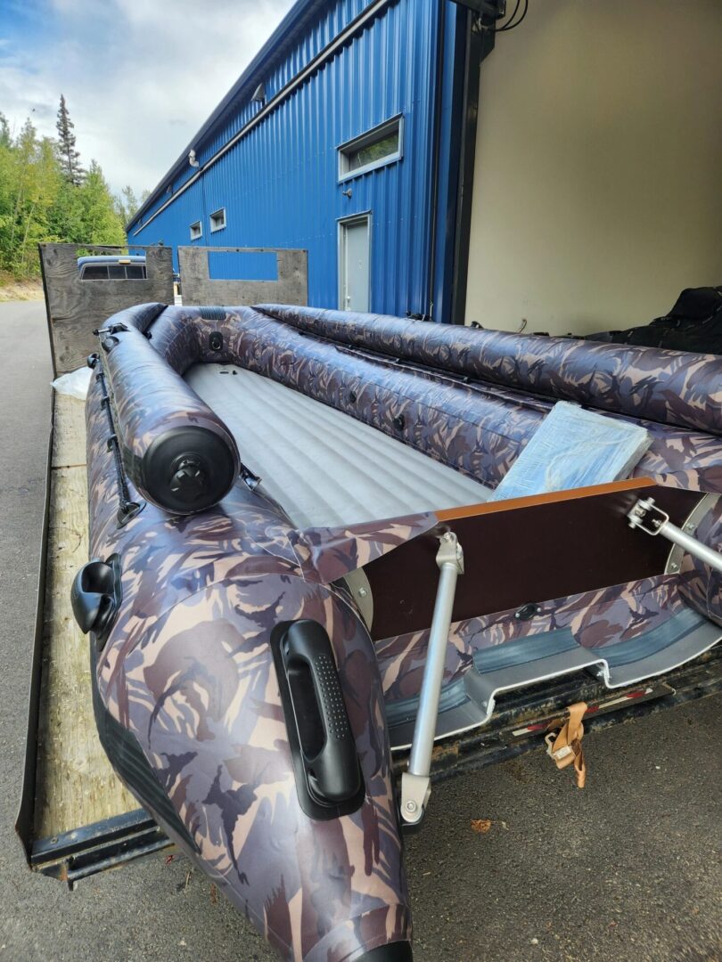 A boat is parked in the back of a truck.