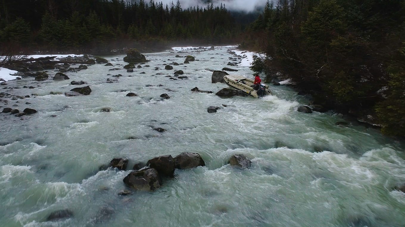 A person in a raft is floating down the river.