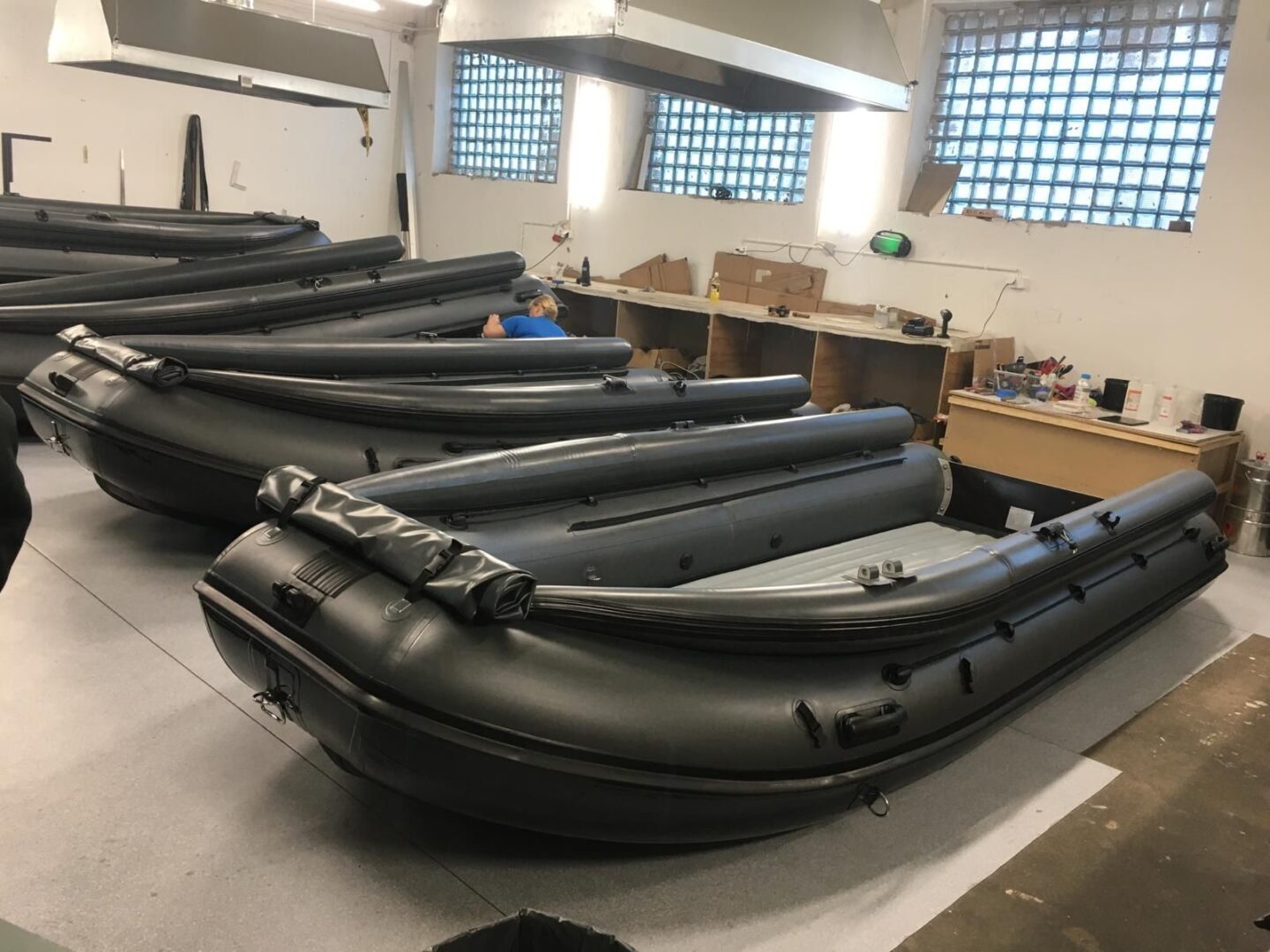 A row of black boats sitting on top of a table.