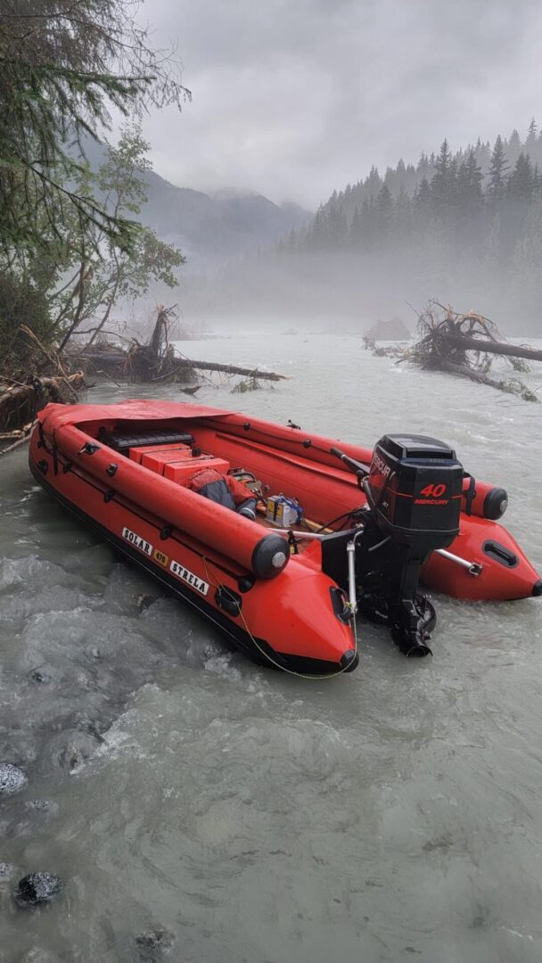 A red boat is sitting in the water