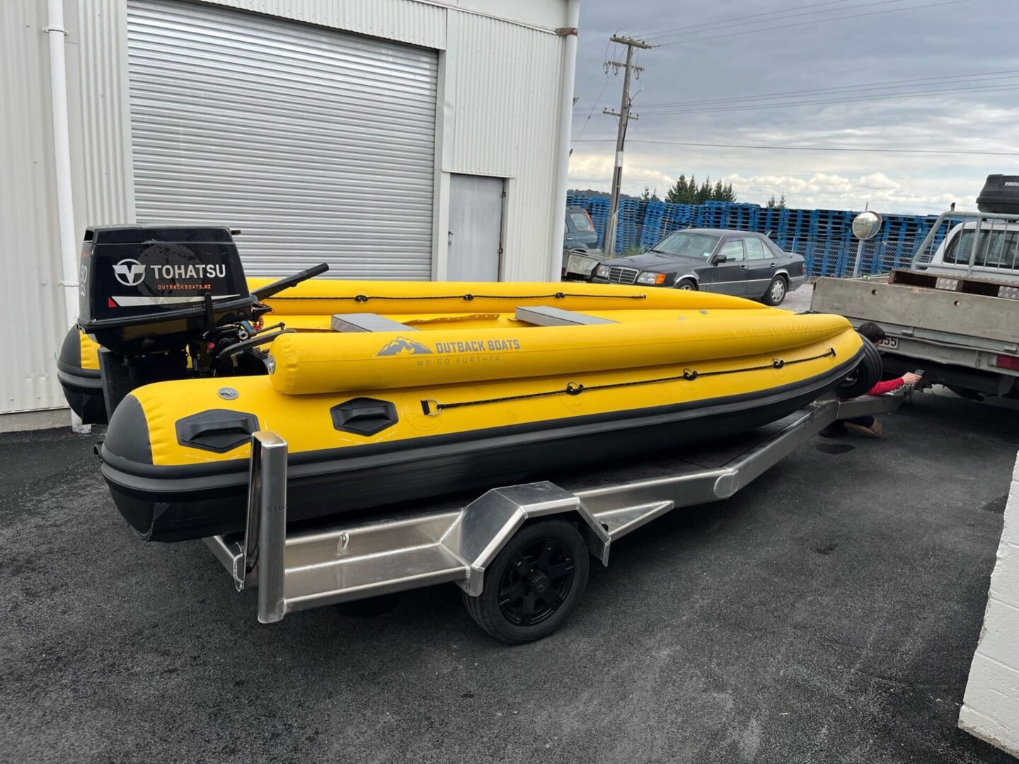 A yellow and black boat is parked in the street.